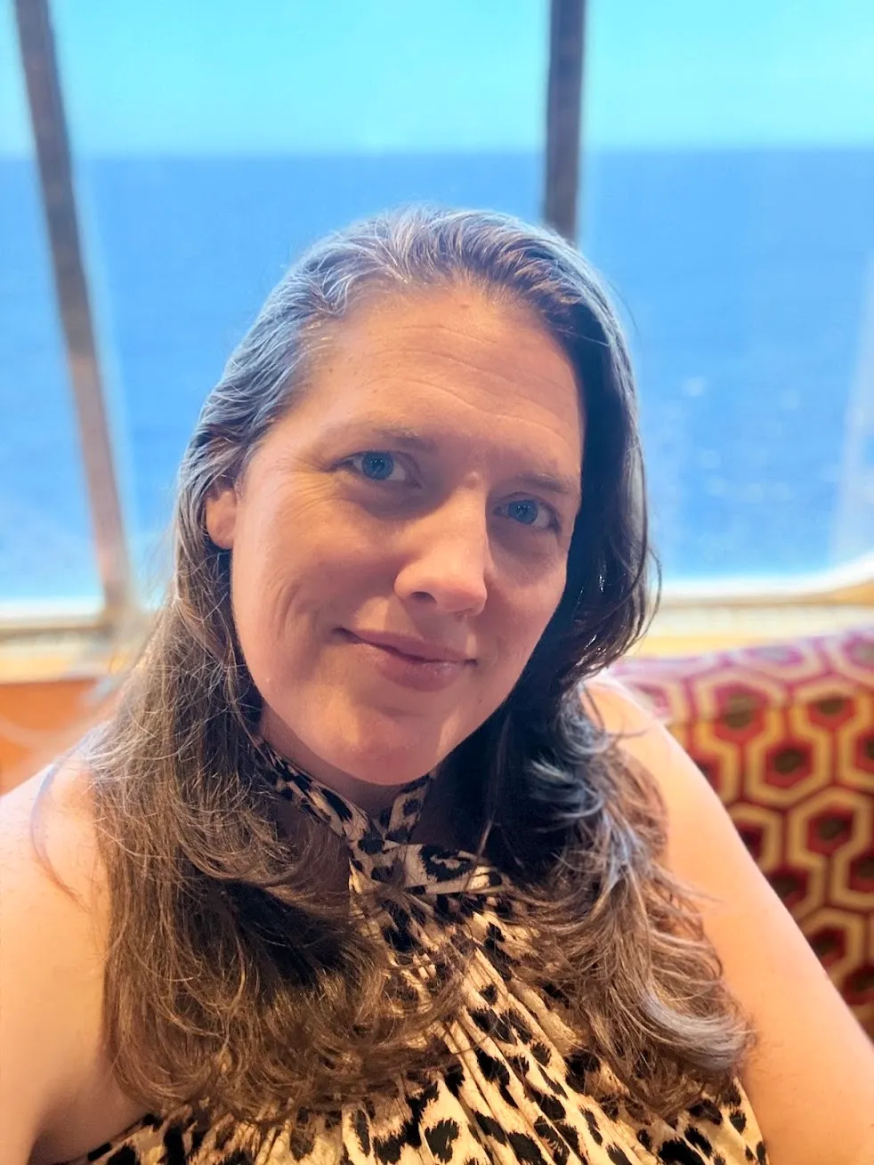 Portrait of Kate Spilsbury aboard a cruise ship with the ocean behind her