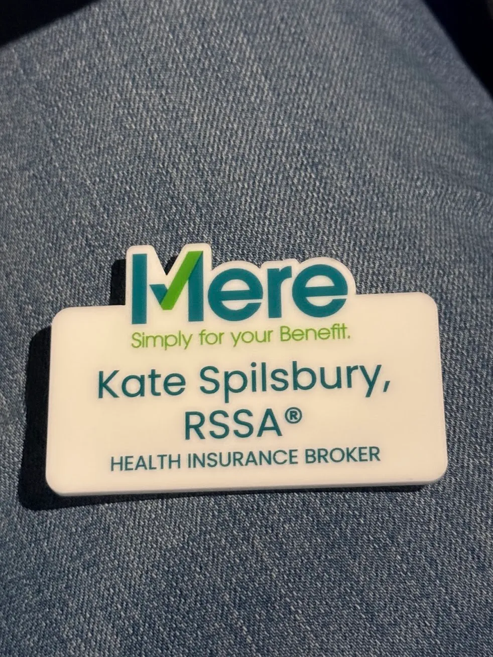 Kate Spilsbury's Mere Benefits name badge reading Kate Spilsbury, RSSA®, Health Insurance Broker
