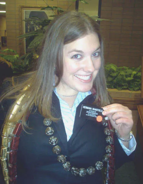 Kate as a missionary in 2006, holding up her name tag